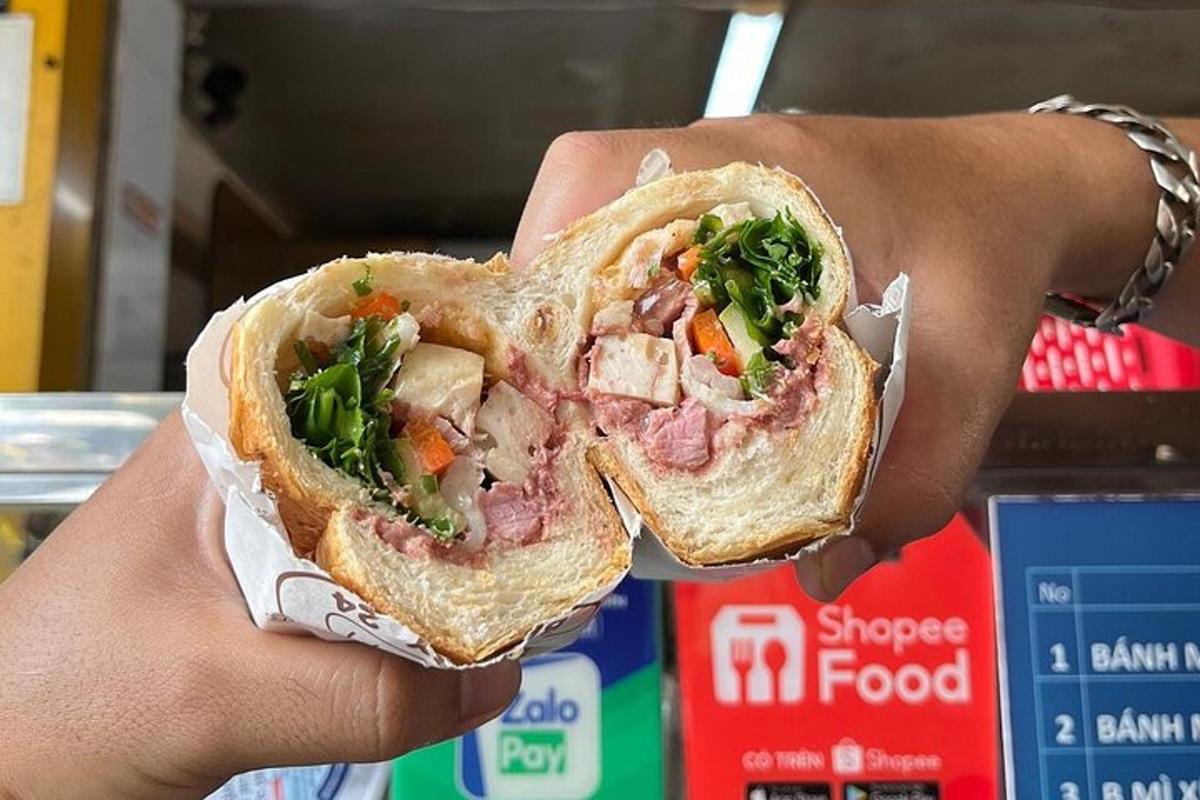 a person holding a sandwich in their hand