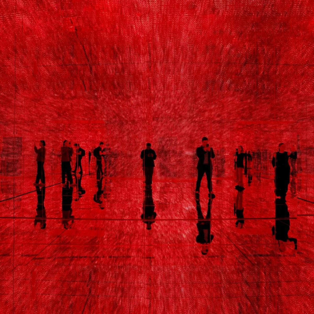 a group of people walking on a red floor
