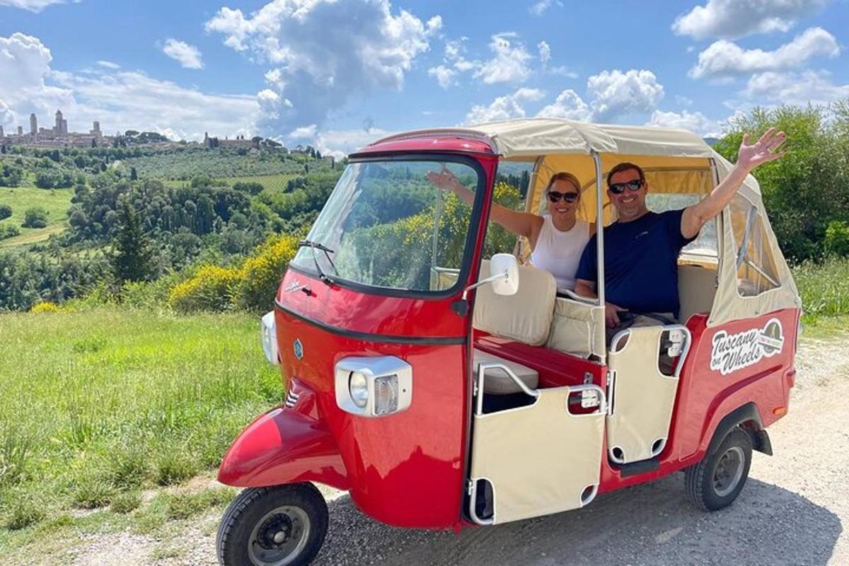 a man and woman riding in a golf cart