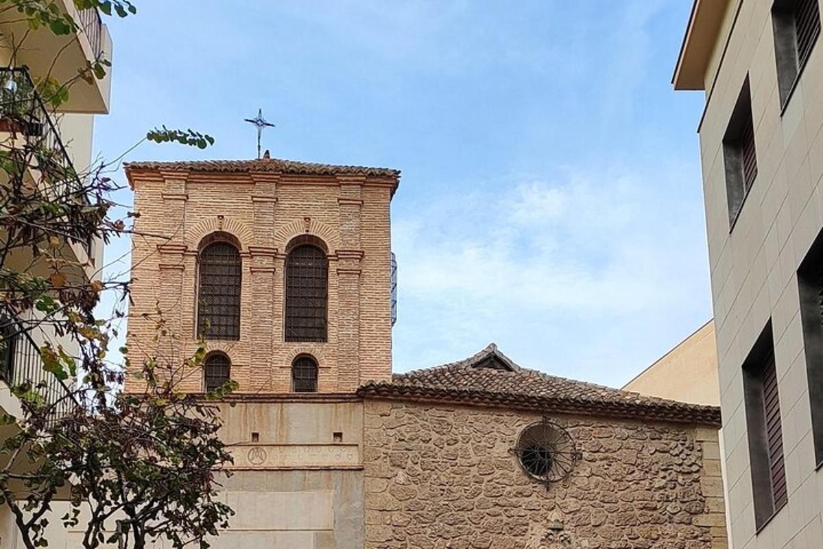a church tower with a cross on top of it