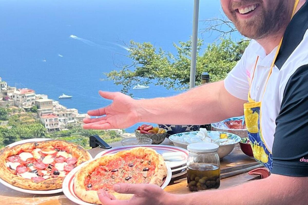 ένας άντρας που κάθεται σε ένα τραπέζι με δύο πίτσες