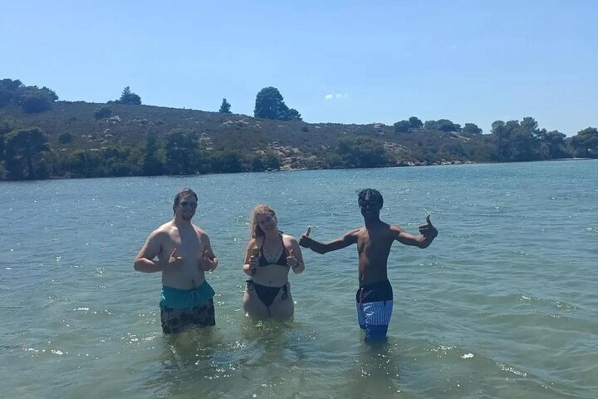 a group of three people standing in the water