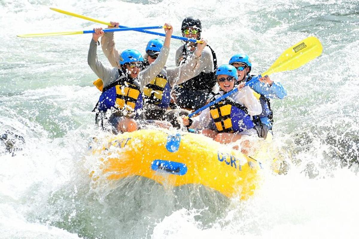a group of people in a raft in the water