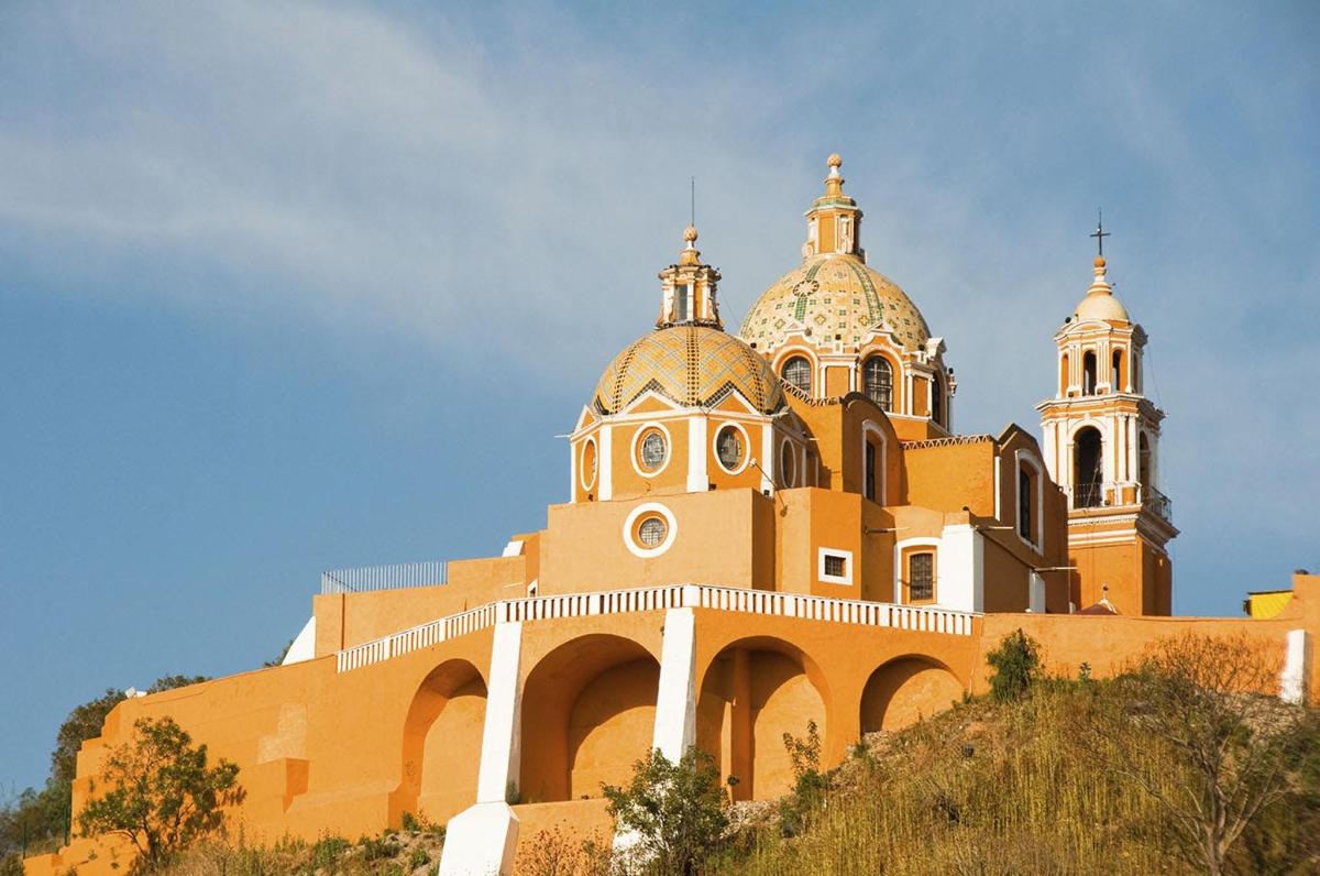 a building with two domes on top of a hill