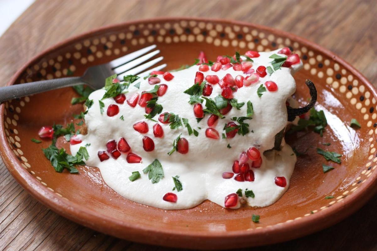 a plate with a dessert with pomegranates and a fork