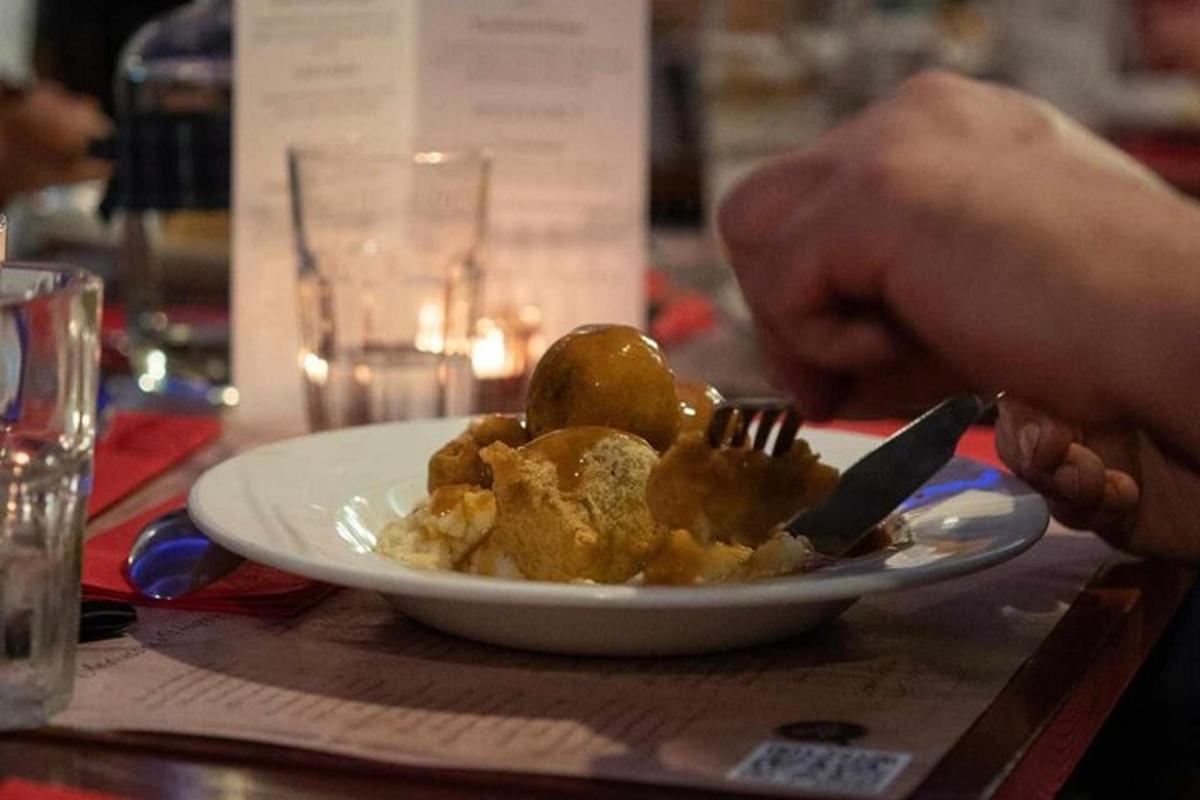 a person eating food on a plate with a fork