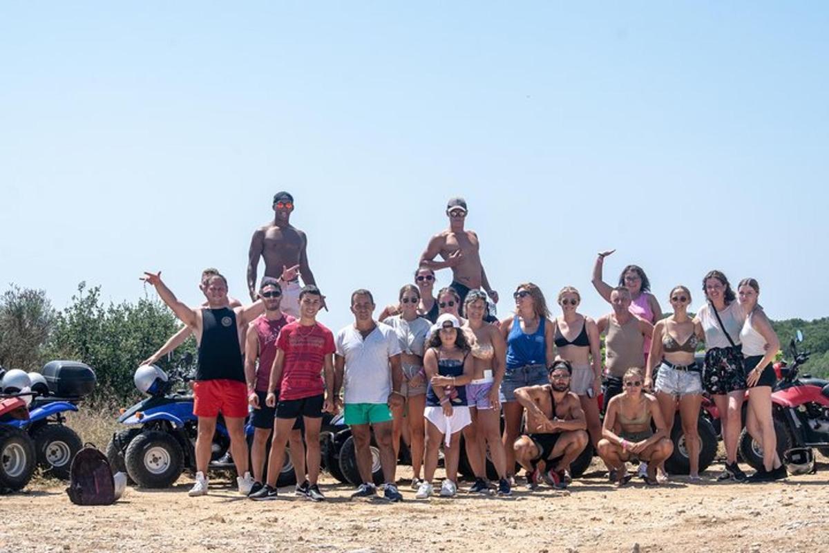 a group of people posing for a picture on the beach