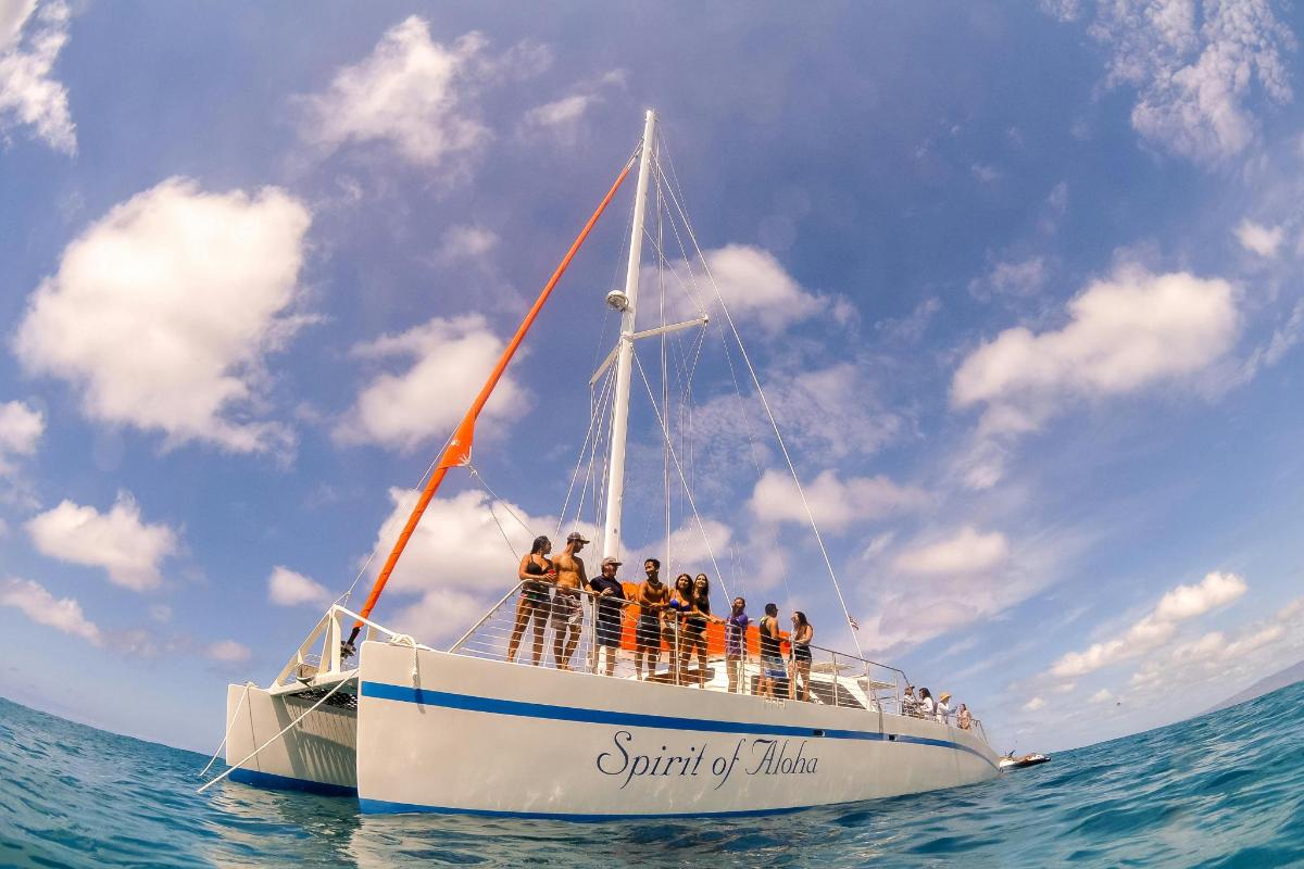 a group of people on a boat in the ocean