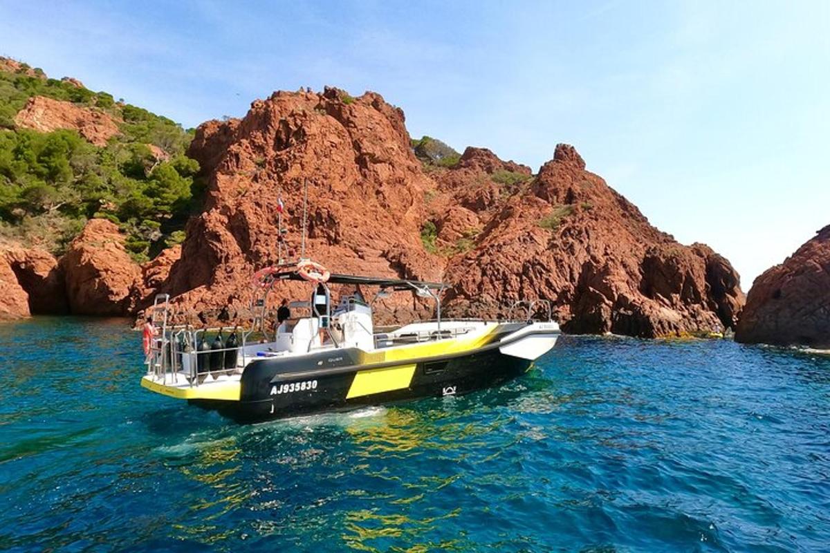 a boat in the water next to some rocks