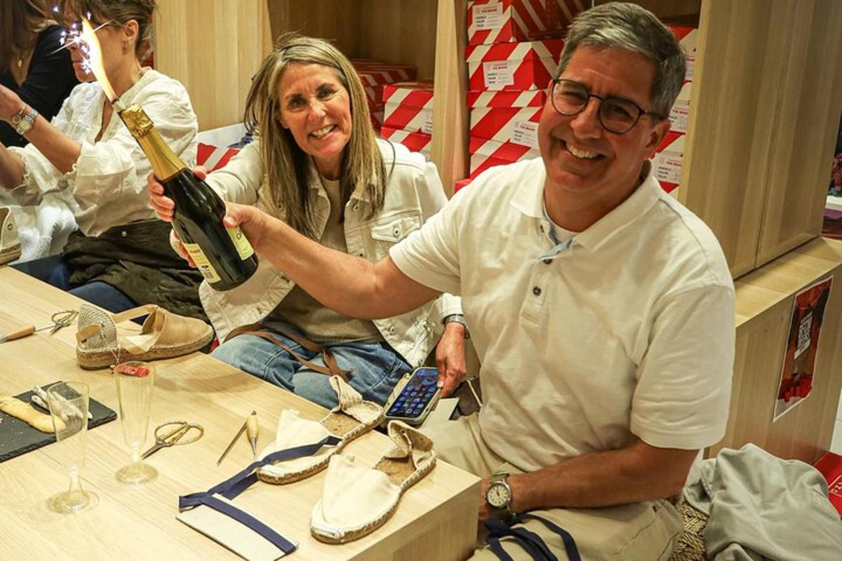 a man holding a bottle of wine next to a woman