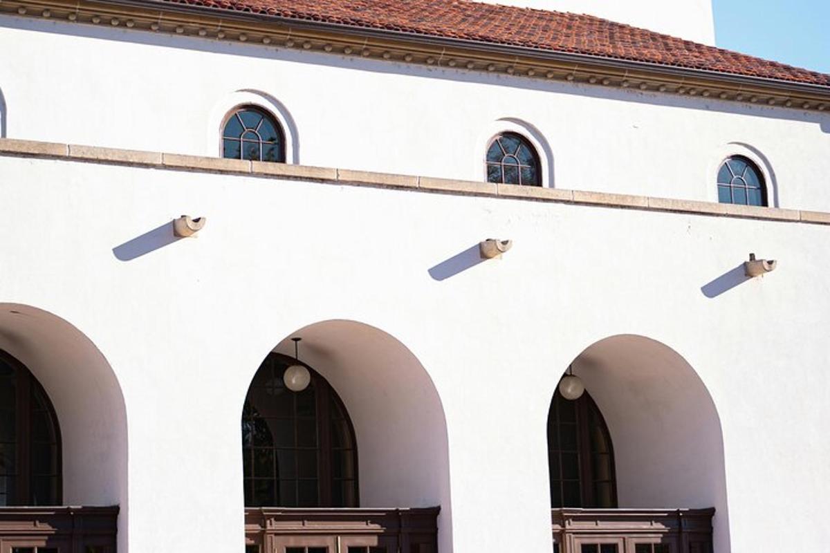 a white building with arches and a red roof