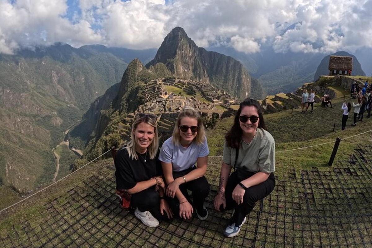 three women sitting on the top of a mountain