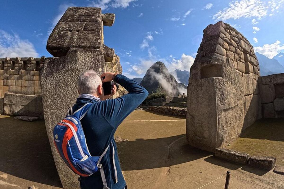a man taking a picture of a mountain