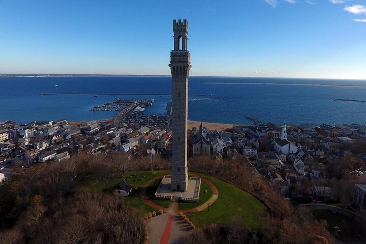 a tall tower in the middle of a city with the water