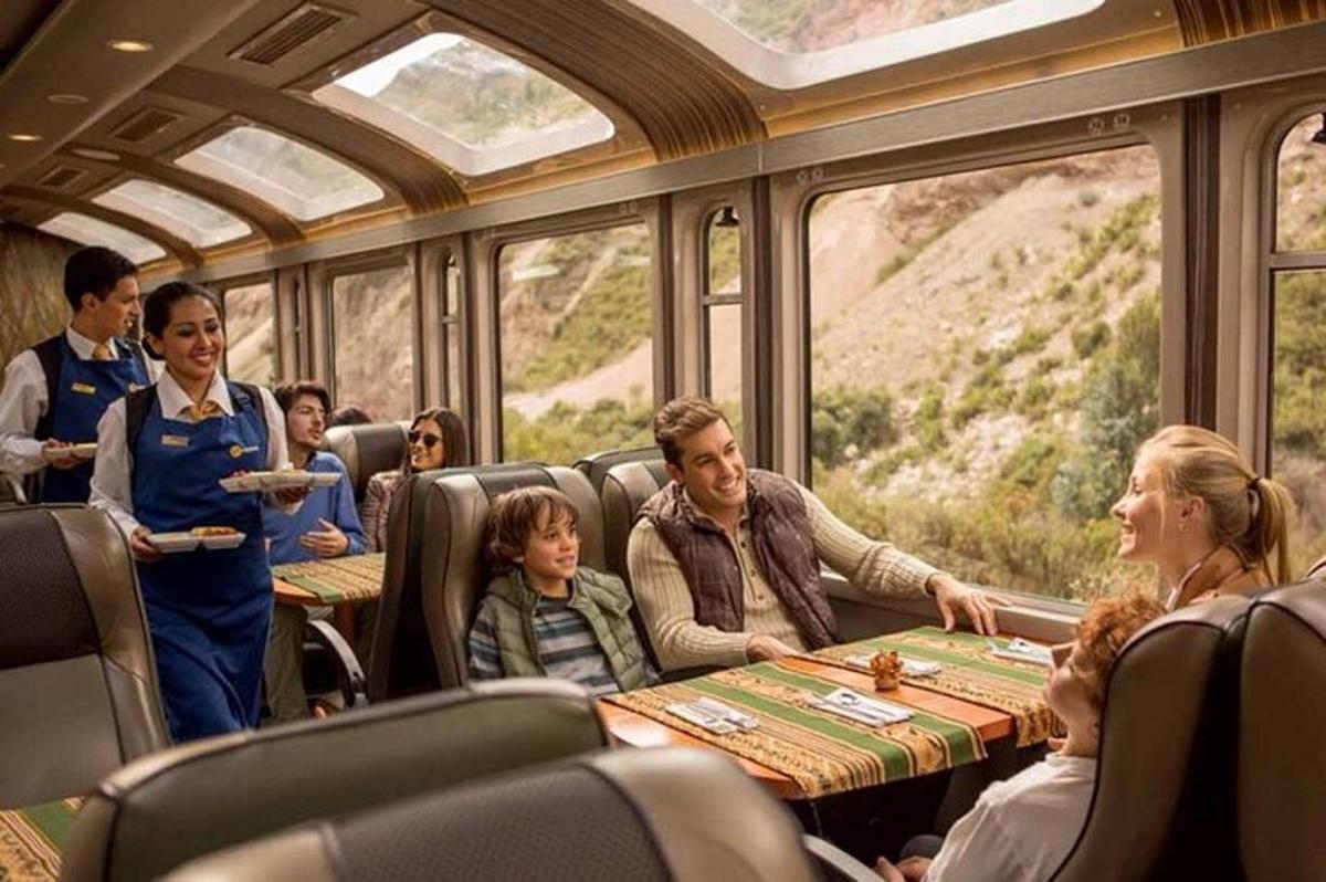 un grup de persones assegudes al voltant d'una taula en un tren