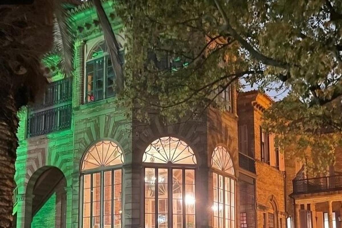a building with green lights on the side of it