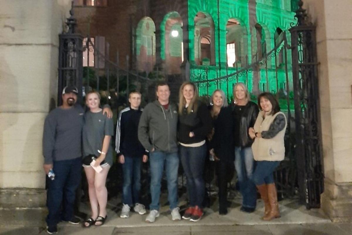 a group of people standing in front of a gate