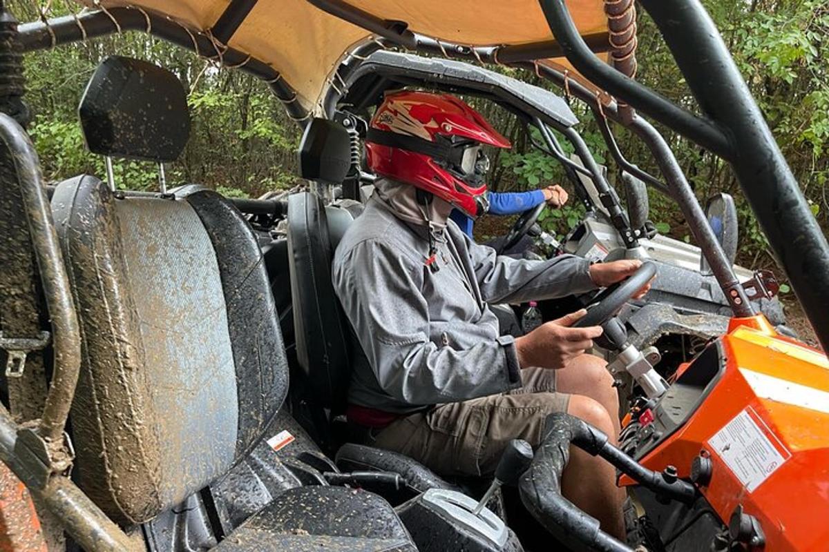 a man wearing a helmet sitting in a vehicle