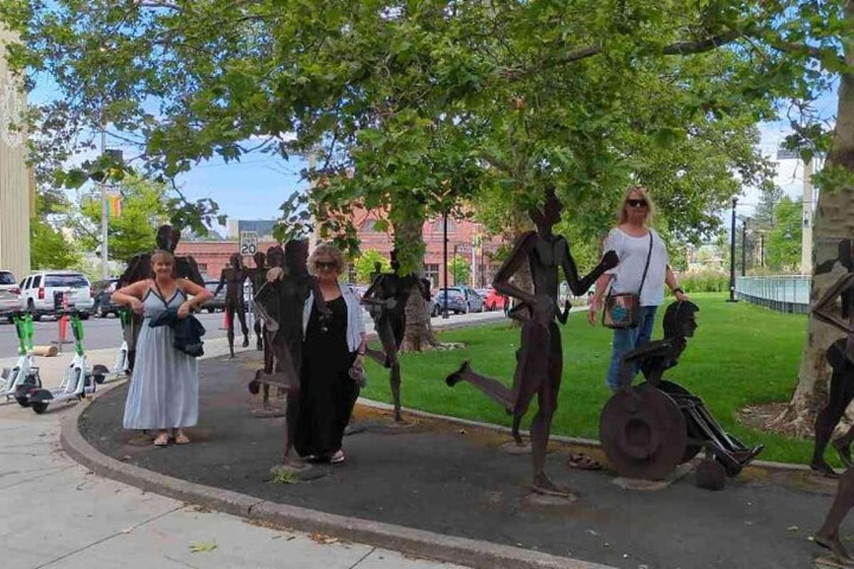 a group of people standing in a circle under a tree