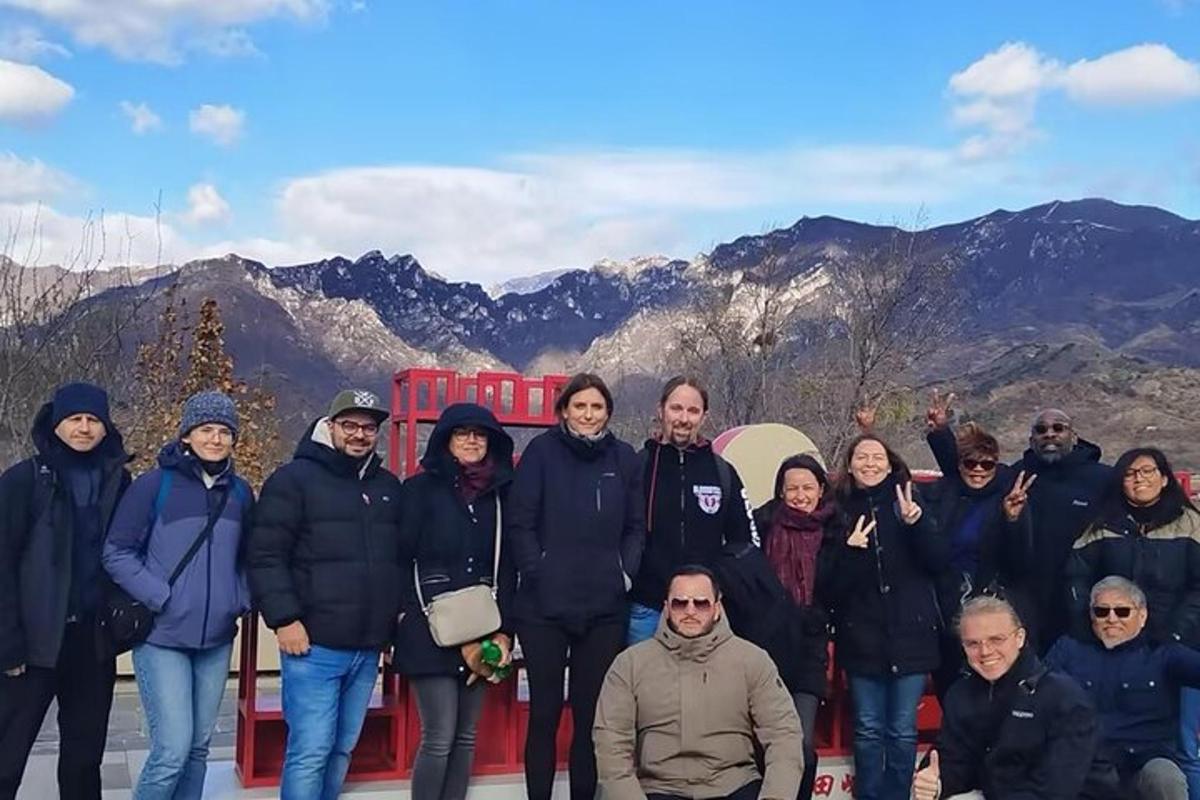 a group of people posing for a picture in front of mountains