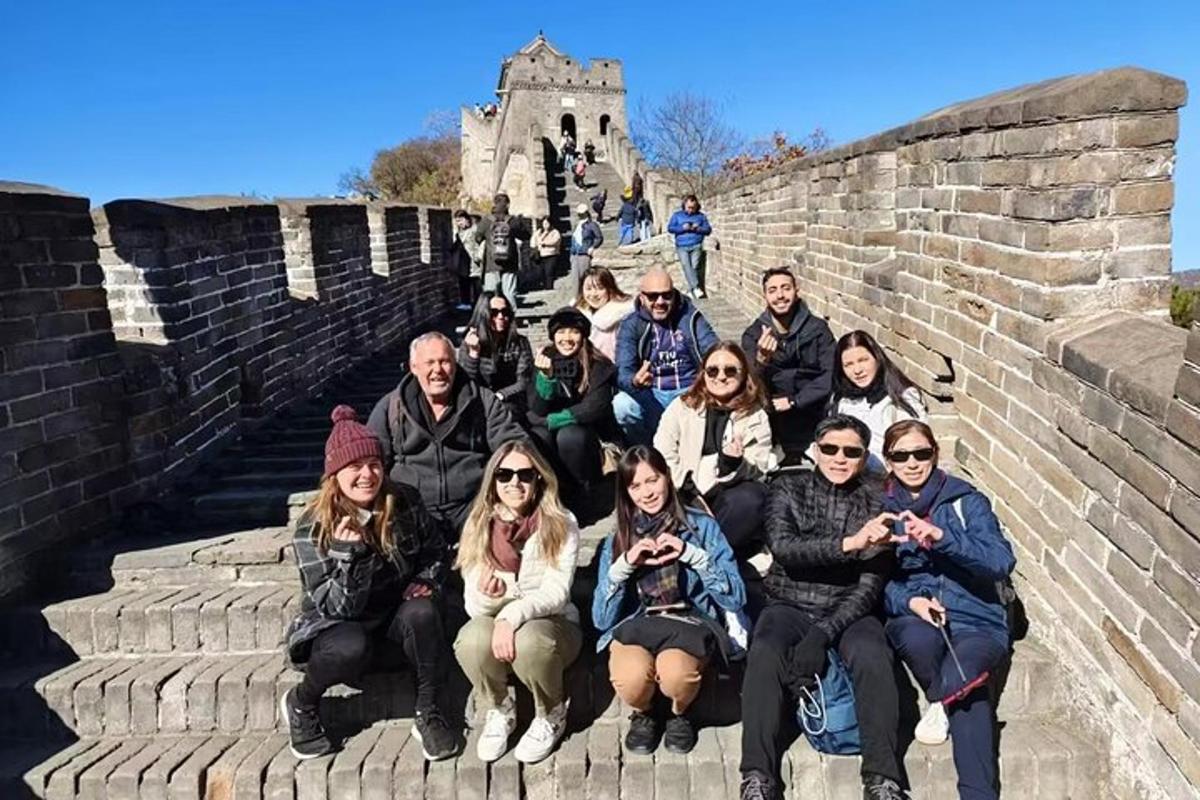 a group of people posing for a picture on the great wall