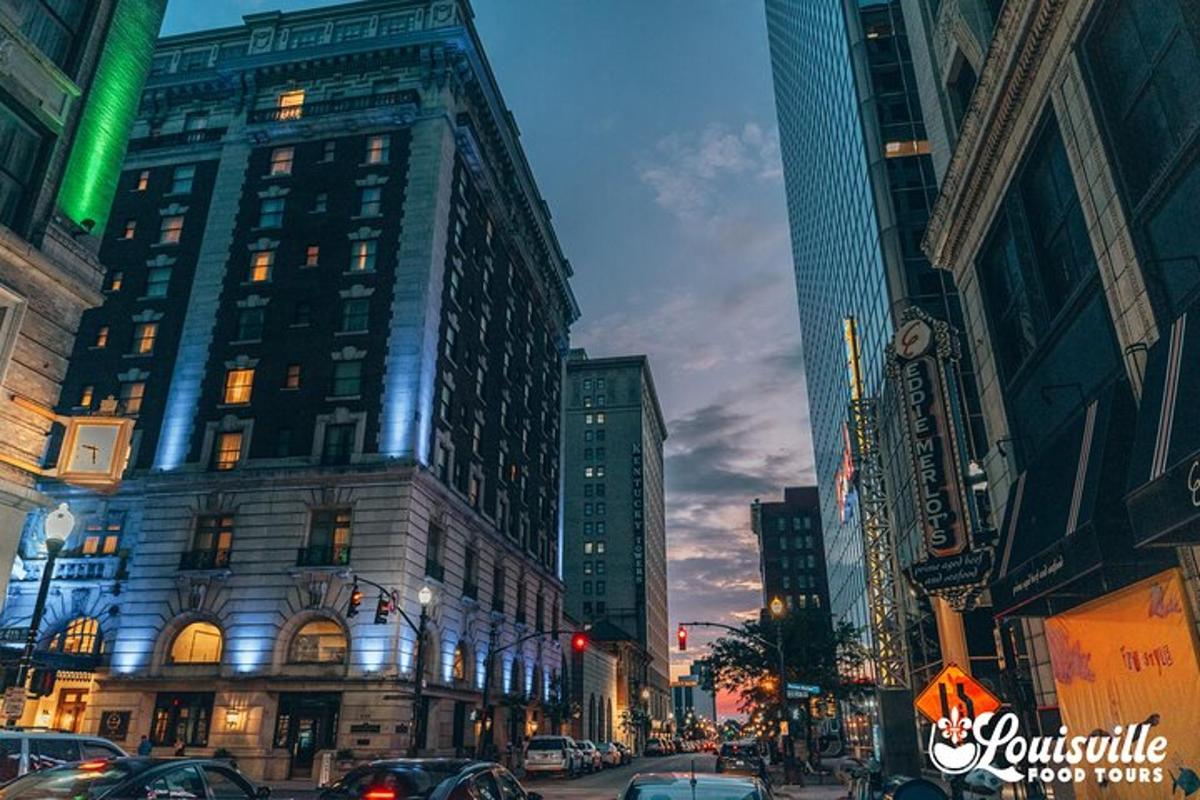 a city street with many tall buildings and cars