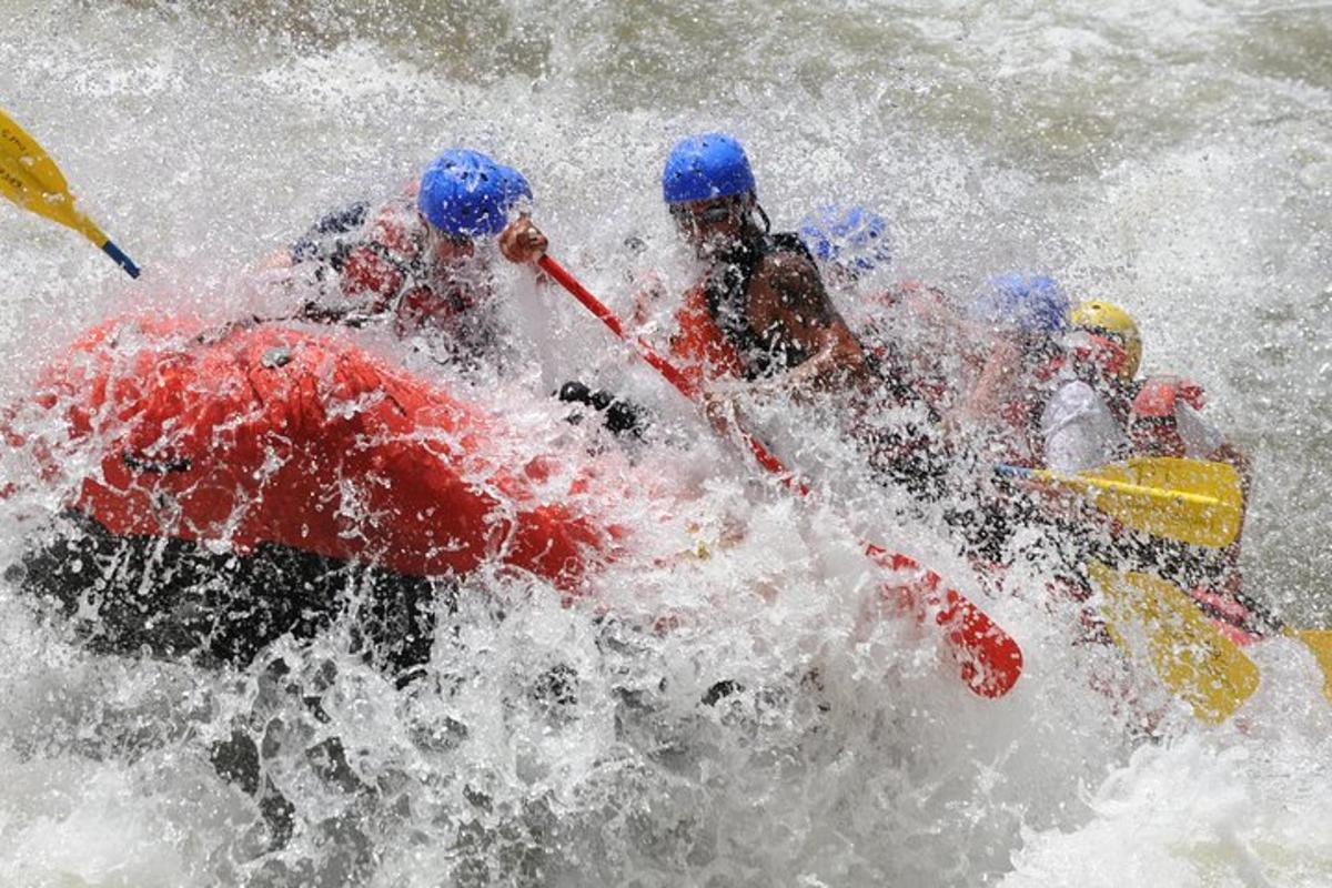 a group of people in a raft in the water