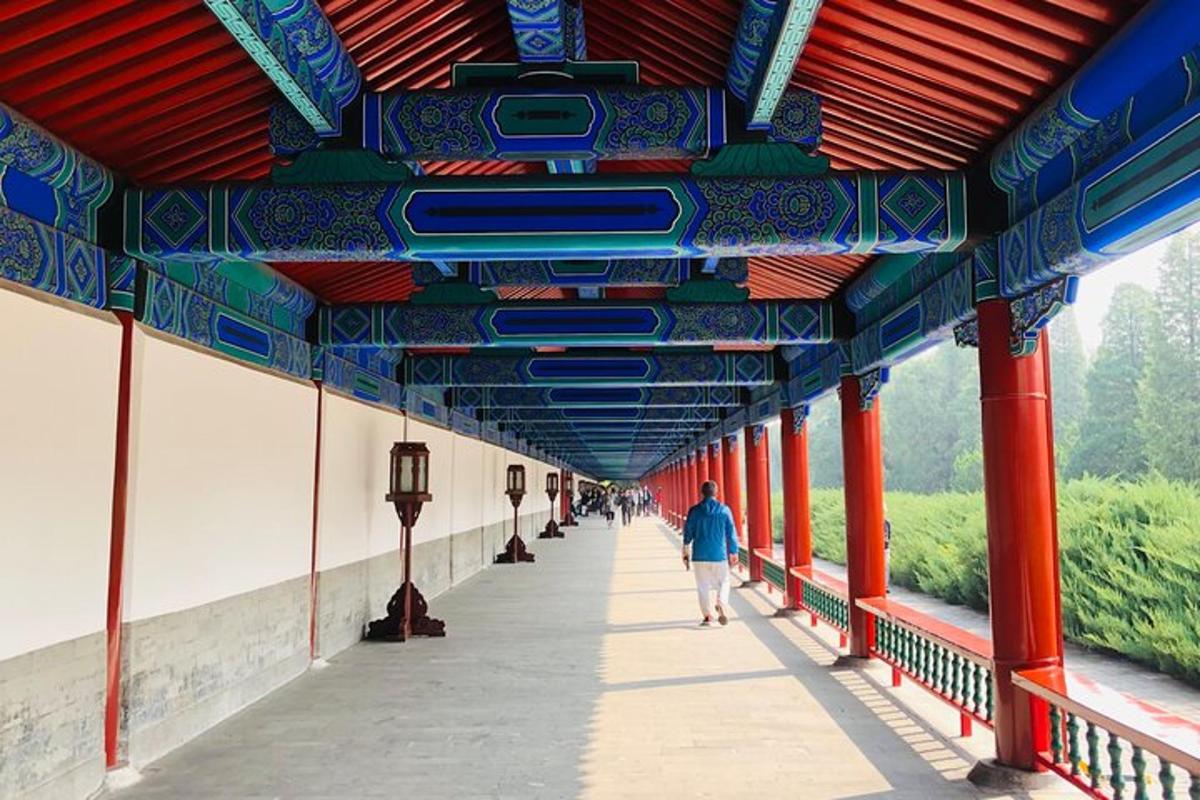 a person walking down a walkway under a building