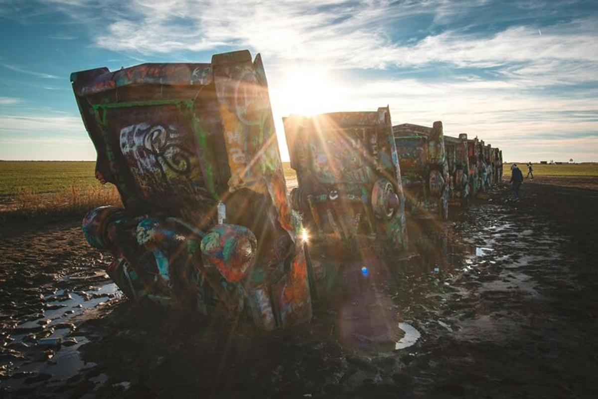 a row ofainers covered in graffiti in a field