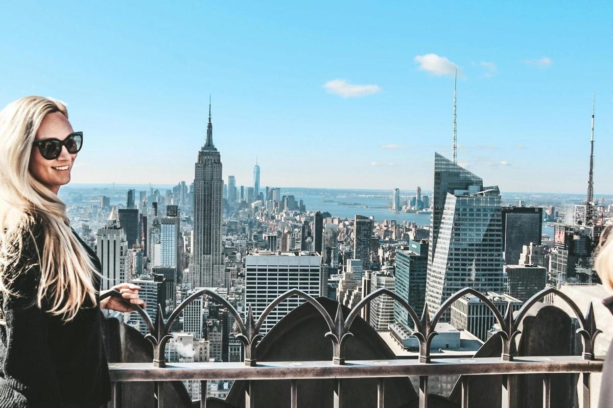a woman standing on the top of a building