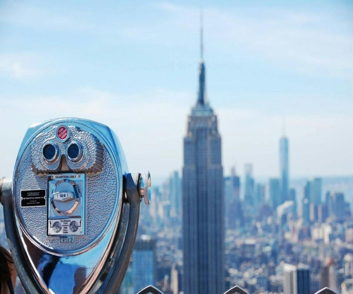 a person is taking a picture of the empire state building