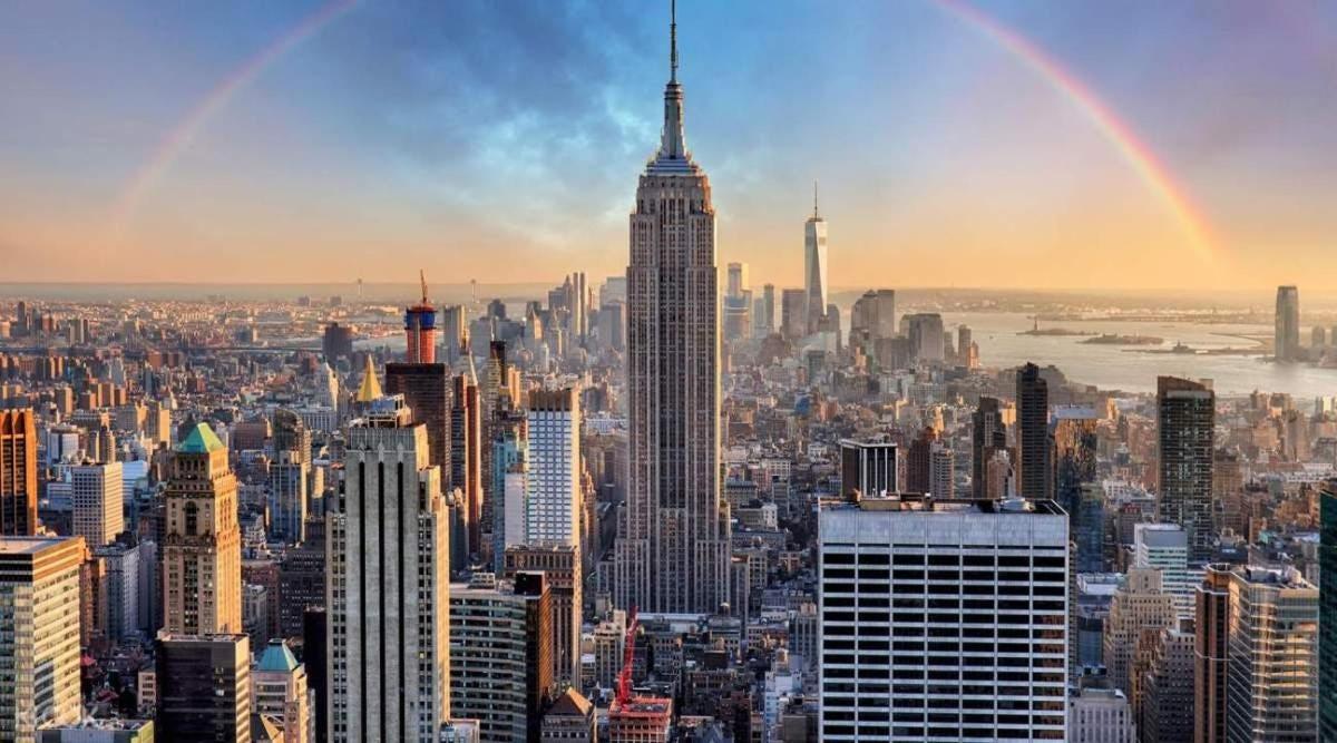 a view of the empire state building with a rainbow