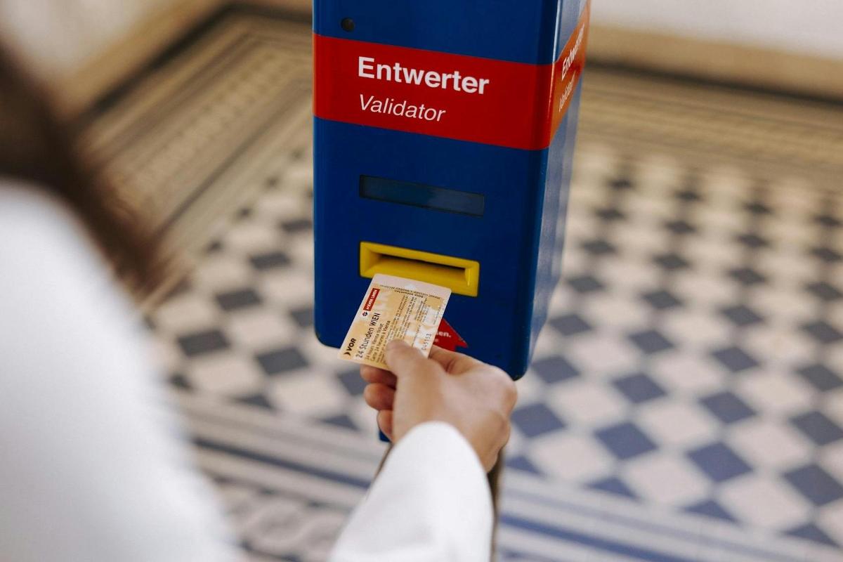 a person is holding up a box with a ticket