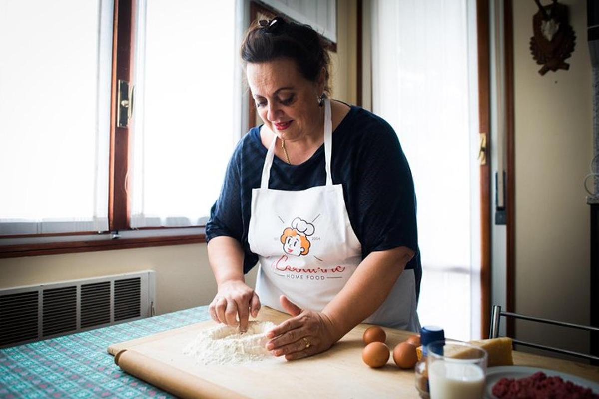 uma mulher em uma cozinha preparando comida em uma tábua de corte