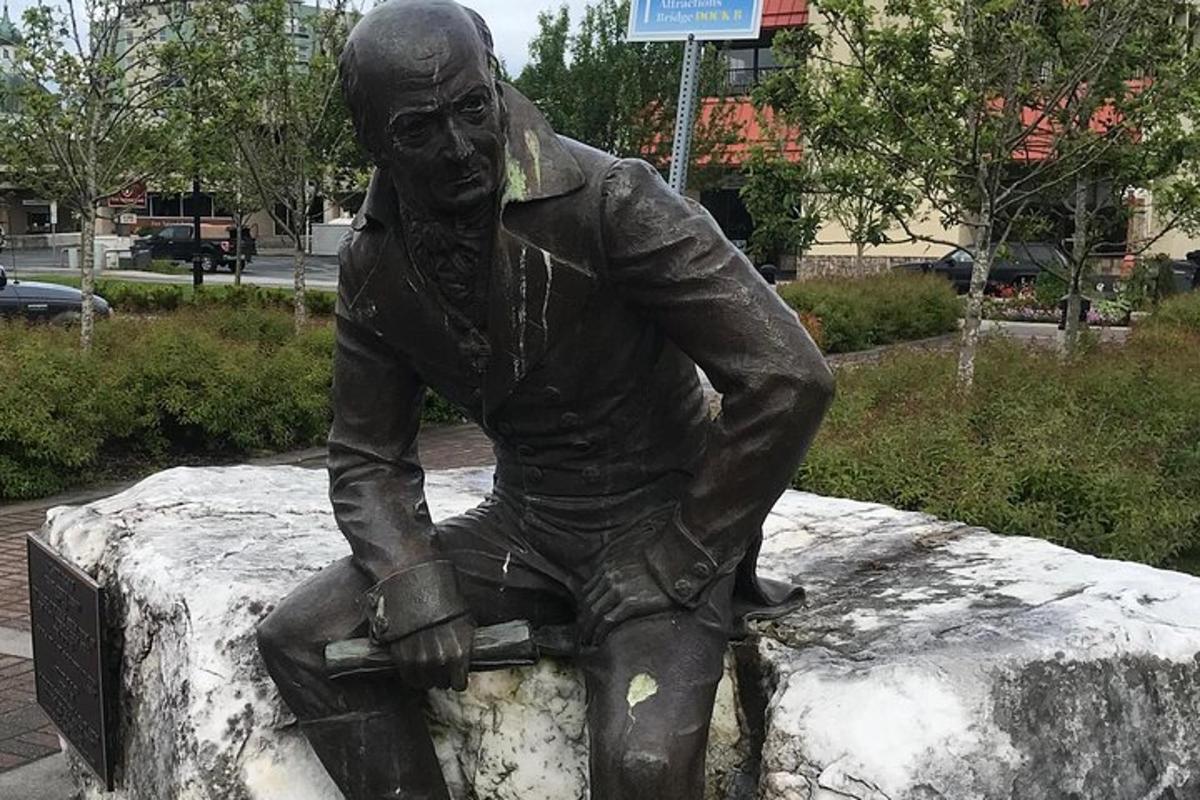 a statue of a man sitting on a rock