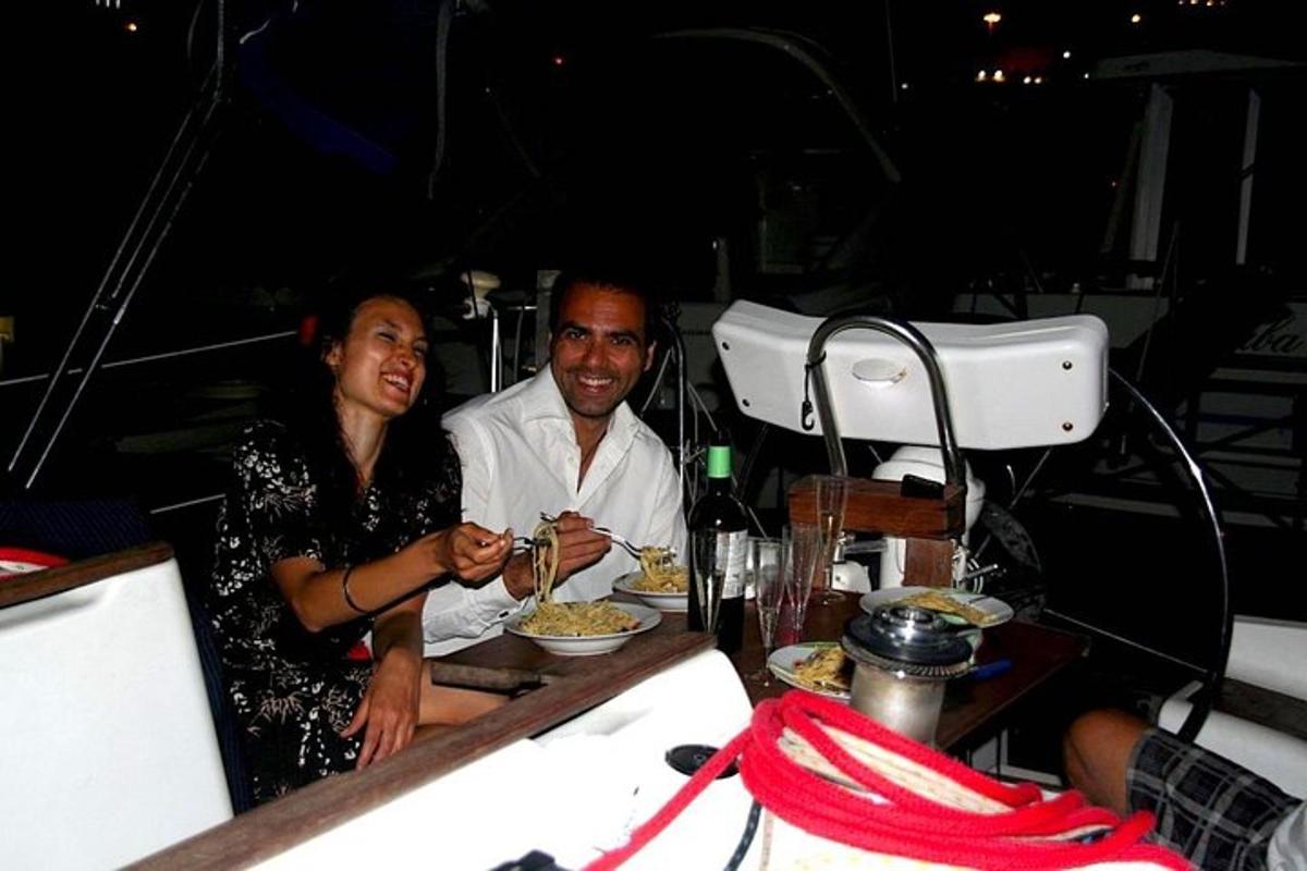 a man and a woman sitting at a table eating food
