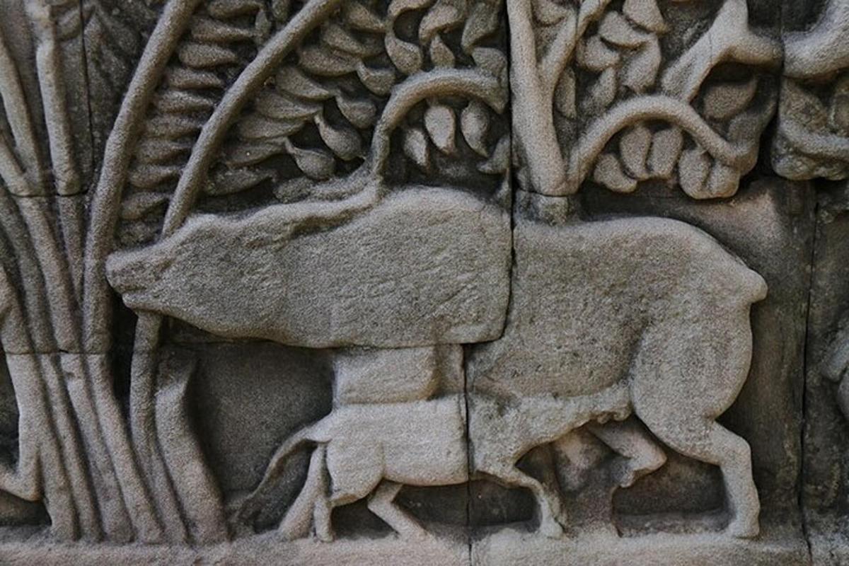 a stone carving of a goat on a wall