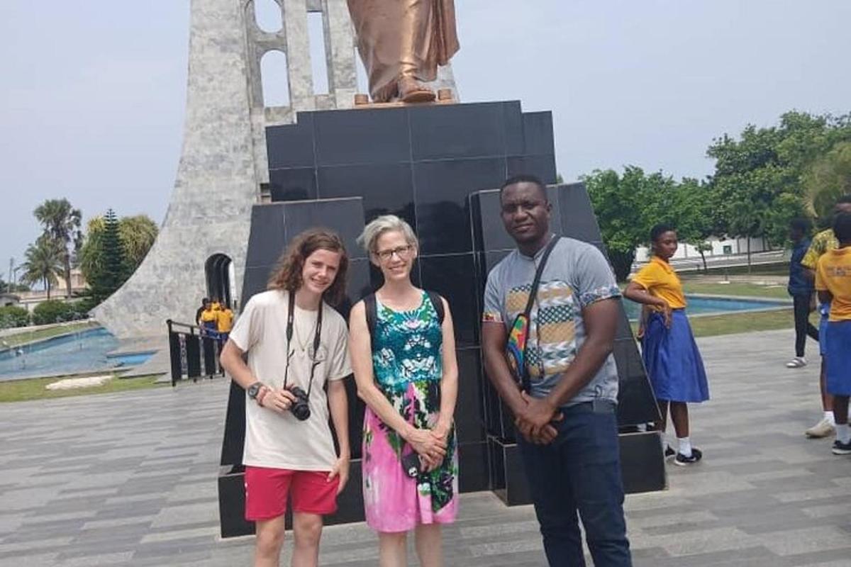 a group of people standing in front of a statue