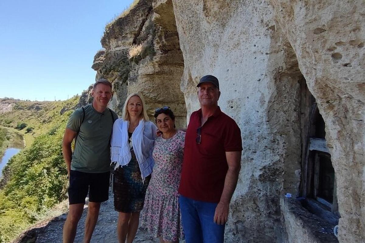 a group of people standing in front of a mountain