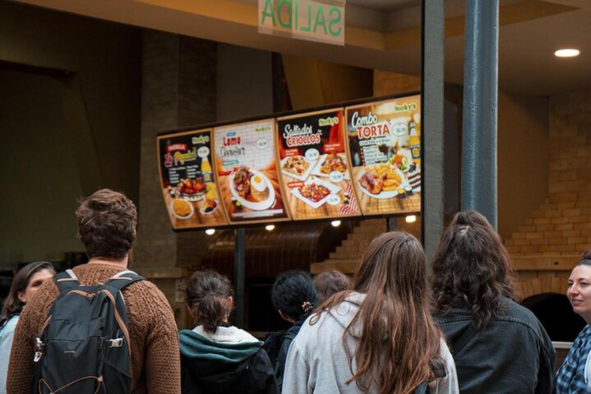 Un grupo de personas esperando en fila para recibir comida