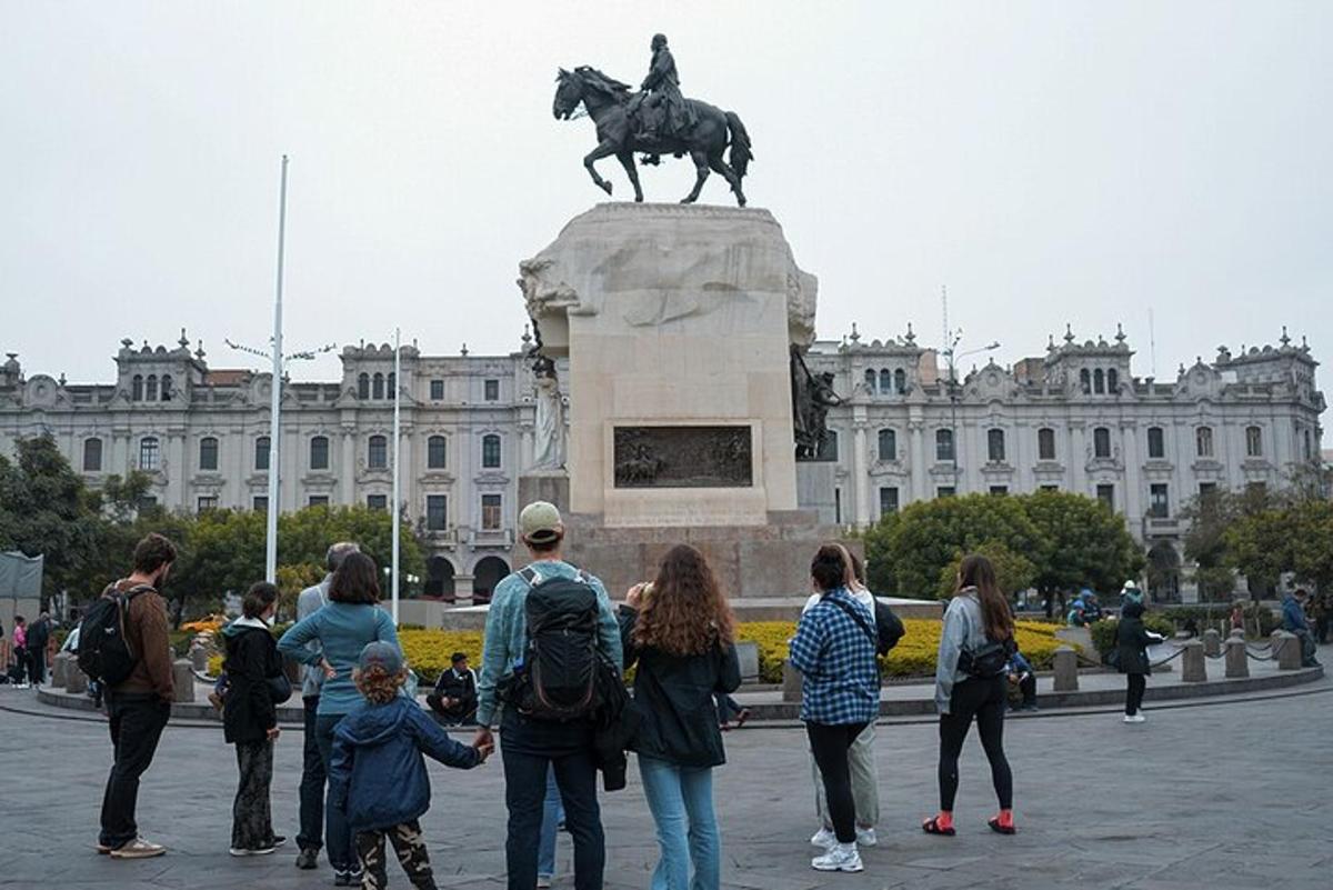 a group of people standing around a statue in front of a building