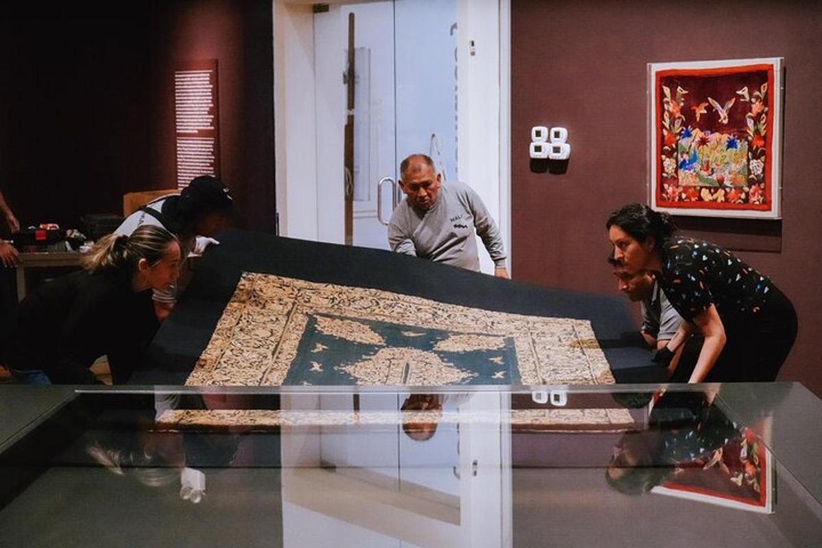 a group of people looking at a glass table