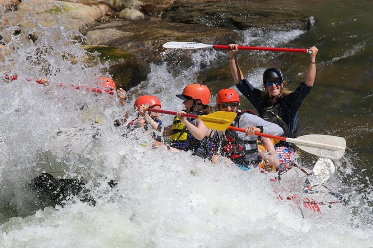 a group of people in a raft in a river