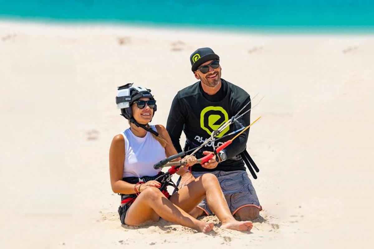 a man and a woman sitting on the beach