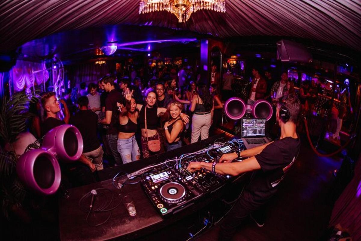a crowd of people standing in a nightclub