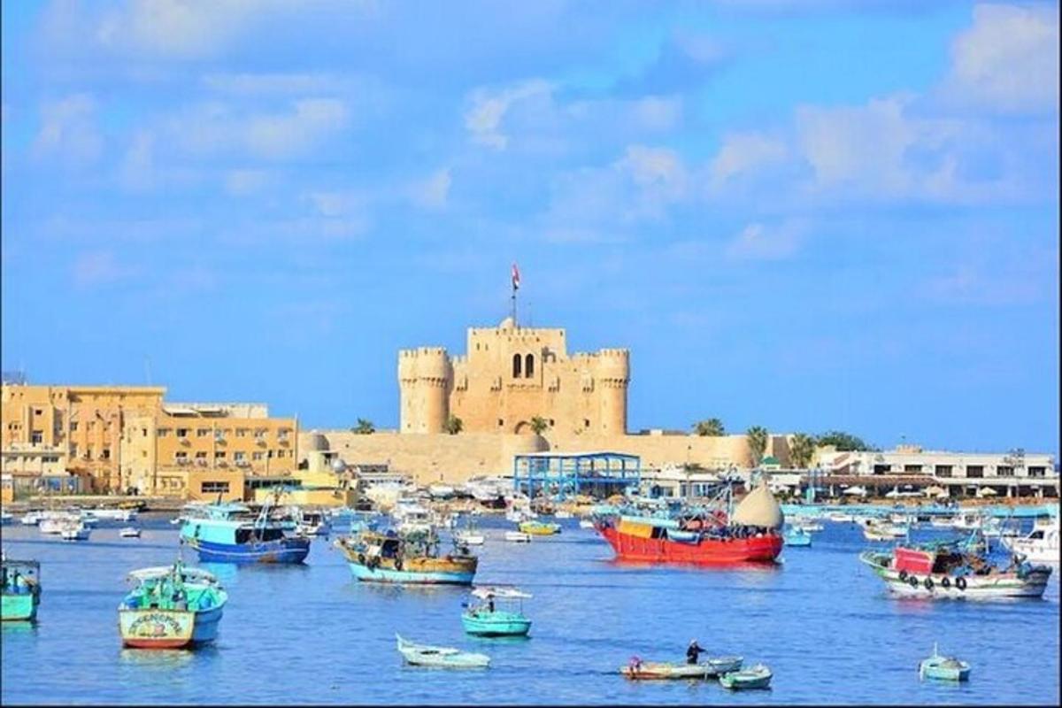 a group of boats in the water in front of a castle