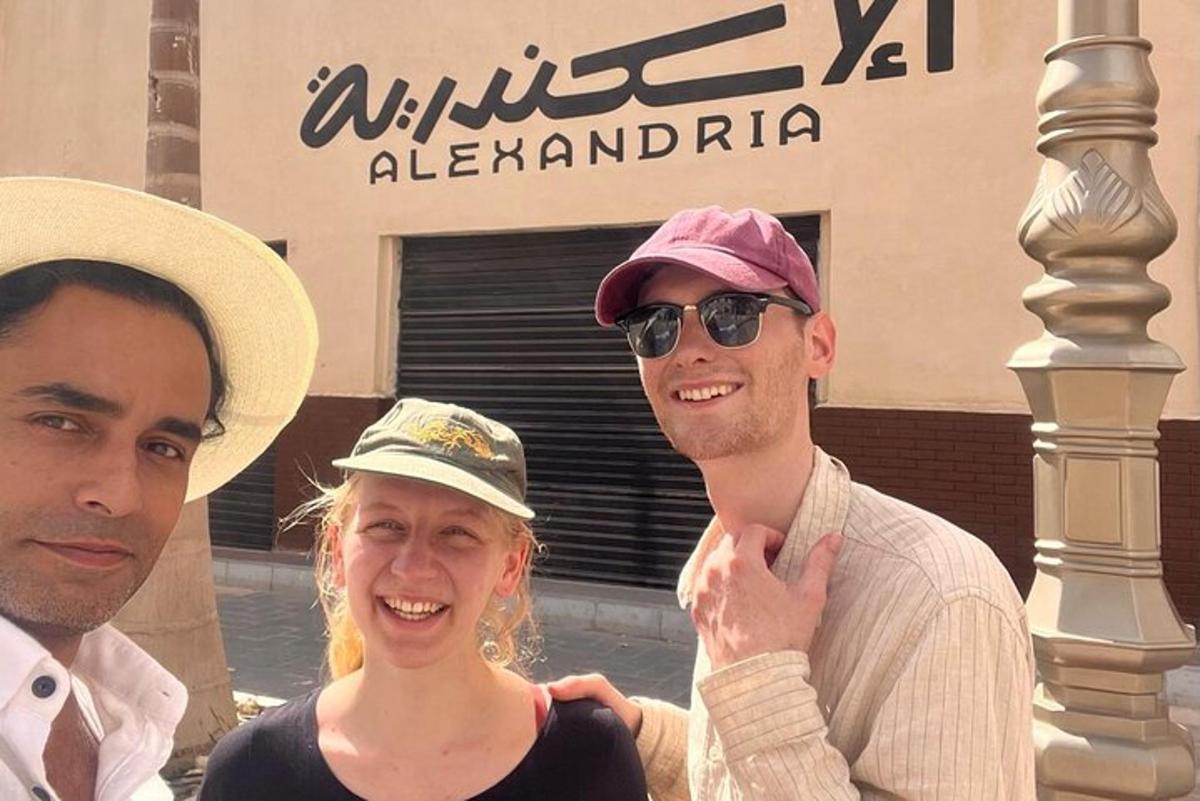 two men and a woman posing for a picture