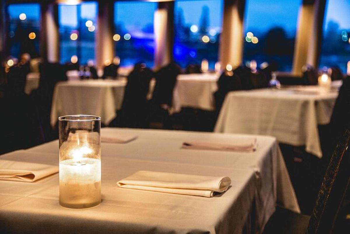 a candle in a glass on a table in a restaurant