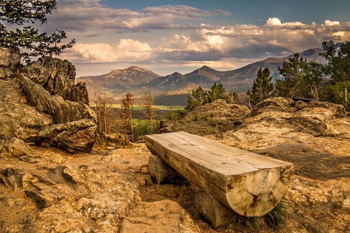 a wooden bench sitting on top of a mountain