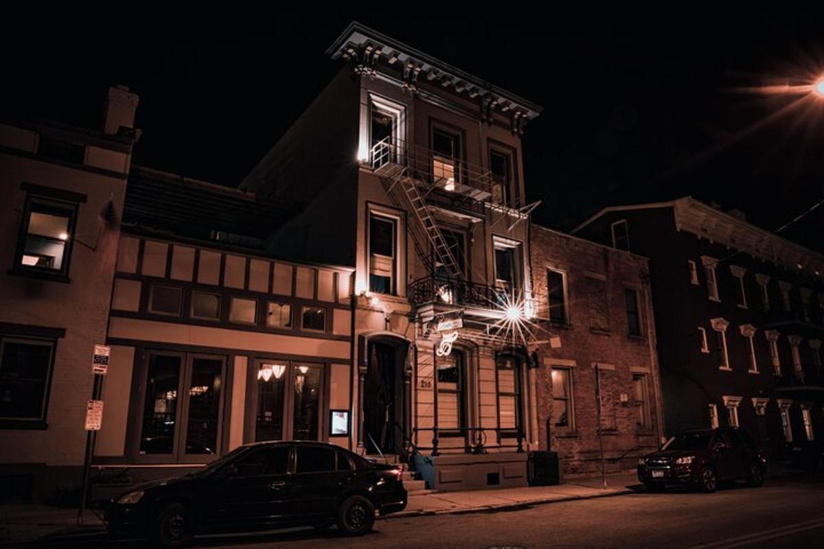 a building with a car parked in front of it at night